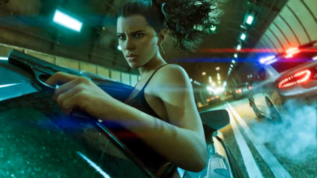 A woman with her hair tied back leans out of the passenger side of a speeding dark car, gripping a pistol, while police cars with flashing lights and smoking tires follow through a green-lit tunnel.