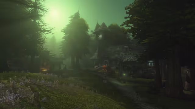 Under a green sky with the sun a pale glow behind the trees, a cobbled road winds past a grassy slope of wildflowers toward a village of dark, steep-roofed houses and a clock tower. Tall pines rise into the fog, and a few windows and a lamp post glow.
