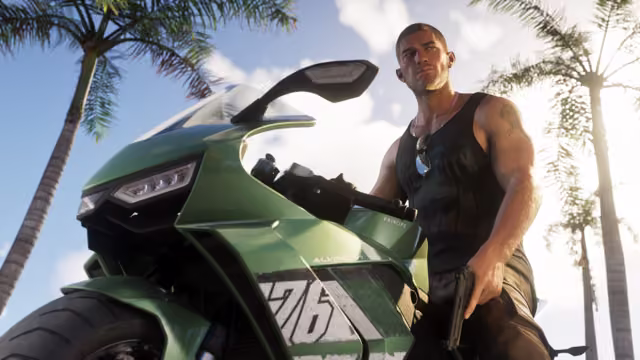 Seen from low down, a muscular man in a black tank top with sunglasses hooked on it sits on a green racing motorcycle numbered 76, holding a pistol at his side, with tall palm trees and a bright sky behind him.
