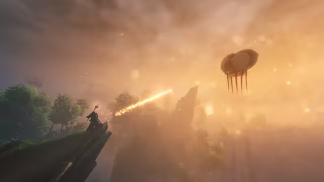 In-game screenshot: a small figure holding a red-tipped staff stands on a mossy rock outcrop while a streak of fire flies across a hazy orange sky toward a large floating creature with hanging tendrils