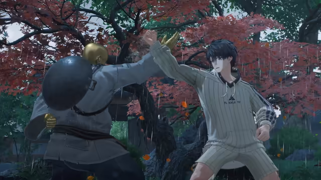 Rain falls in a garden of red maple and green trees: at left, seen from behind, a broad fighter in gray clothes with a golden head, golden hands and a large black wok on his back raises an arm; at right a dark-haired young man in a cream striped hoodie and shorts blocks it with a raised forearm. Orange leaves drift through the air and no game interface is shown.