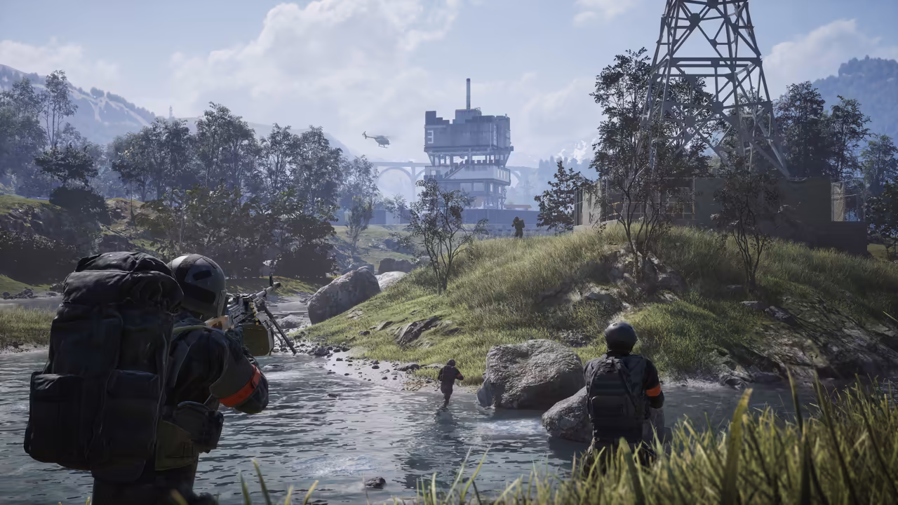 A soldier with a huge pack and a machine gun crosses a shallow river, another stands on the rocks ahead and a third runs up the bank; a steel lattice tower, a multistory concrete tower and a helicopter rise beyond.