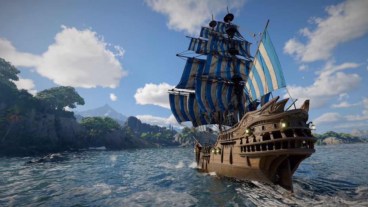 A tall wooden galleon with an ornate carved stern and several masts of blue and white striped sails sails across choppy blue water. Behind it rise green cliffs with palm-like trees and a distant mountain peak under a bright sky with white clouds.