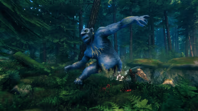 A huge blue troll with yellow eyes and wisps of pale hair swings a clawed arm while crouching in ferns among tall pine trunks; a small Viking beside a mossy boulder strikes at it