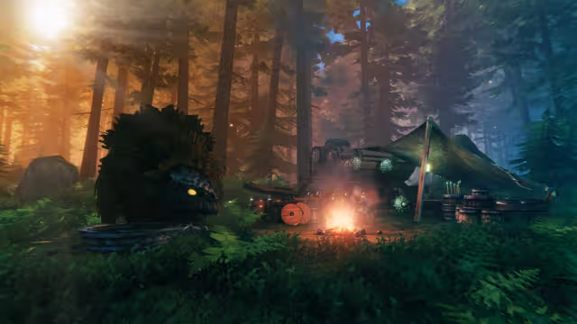 A campfire burns beside a canvas-roofed trader's wagon in a sunlit pine forest; a shaggy lox rests in the foreground.
