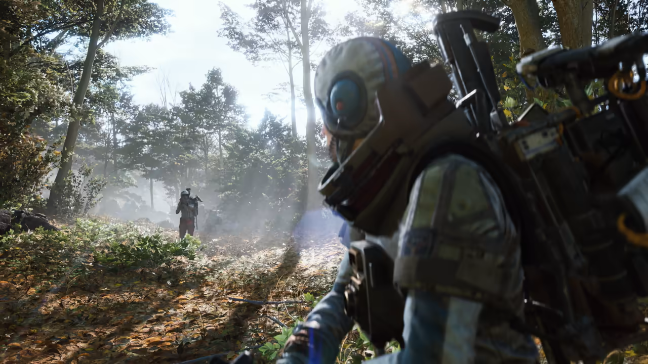 Over-the-shoulder view of a helmeted Raider among tall trees and ferns, a second person standing far down a misty path.