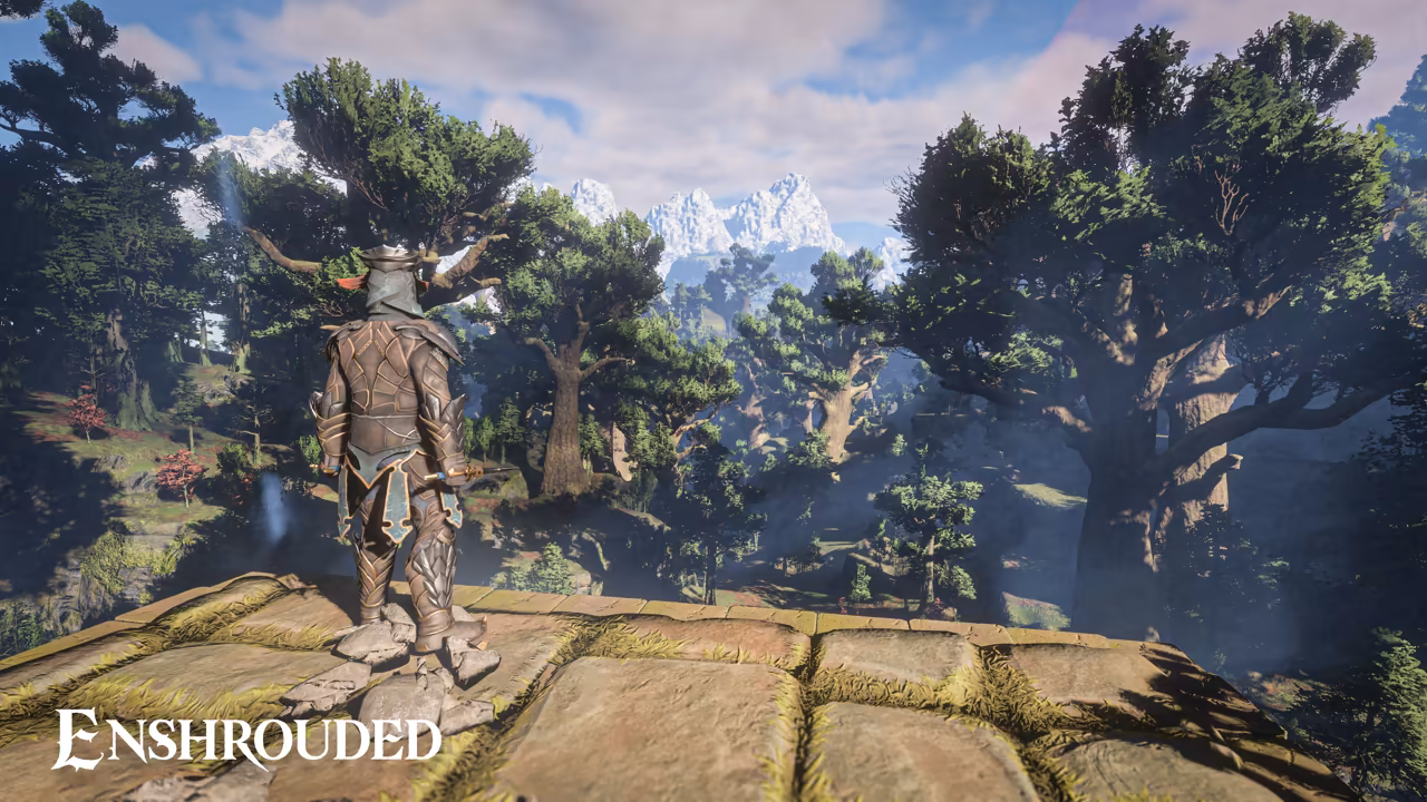 Seen from behind, a figure in layered brown leather armor and a mask with branching antlers stands on a mossy stone platform. Below spreads a forest of huge, broad-crowned trees with thick trunks, and jagged snowy mountains rise under a blue sky with clouds. The Enshrouded logo is at bottom left.