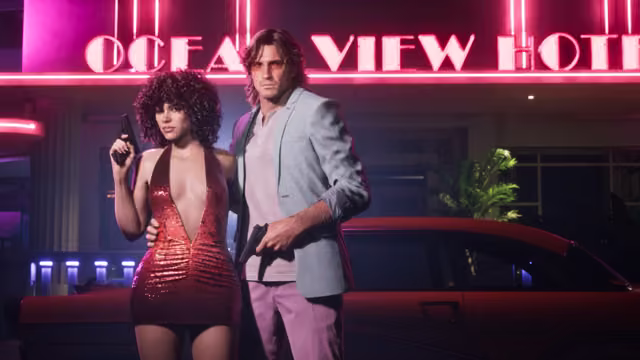 A woman with big curly hair in a short sequined red halter dress and a man with feathered hair in a pale blazer, pink shirt and pink trousers pose with pistols in front of a glowing pink sign reading Ocean View Hotel and a red sports car.