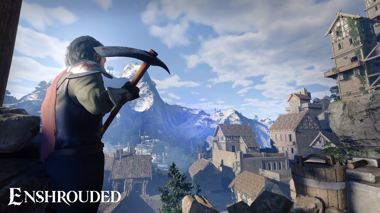 Seen from the side at left, a man with tied-back hair in a dark coat with a red scarf holds a pickaxe over his shoulder and looks down at a village of stone and timber-framed houses with brown tiled roofs, built on a steep rocky slope. A tall timbered tower stands at right, and a snow-capped mountain rises under white clouds. The Enshrouded logo is at bottom left.