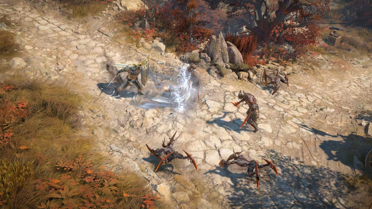 Top-down view of a stone path with tufts of golden grass and red bushes. A warrior with a round shield swings at a horned, armored creature; three spiky crab-like creatures with orange blades crawl toward him.