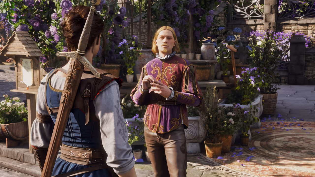 Over the shoulder of a woman with auburn hair tied up, in a blue dress and white blouse with a long sword across her back, a young man with chin-length blond hair and a small beard gestures as he speaks. He wears a purple doublet with gold embroidery and a white ruff. Around them are clay pots and stone planters of purple and white flowers, a wooden birdhouse and a patterned rug laid on the paving. No game interface is shown.