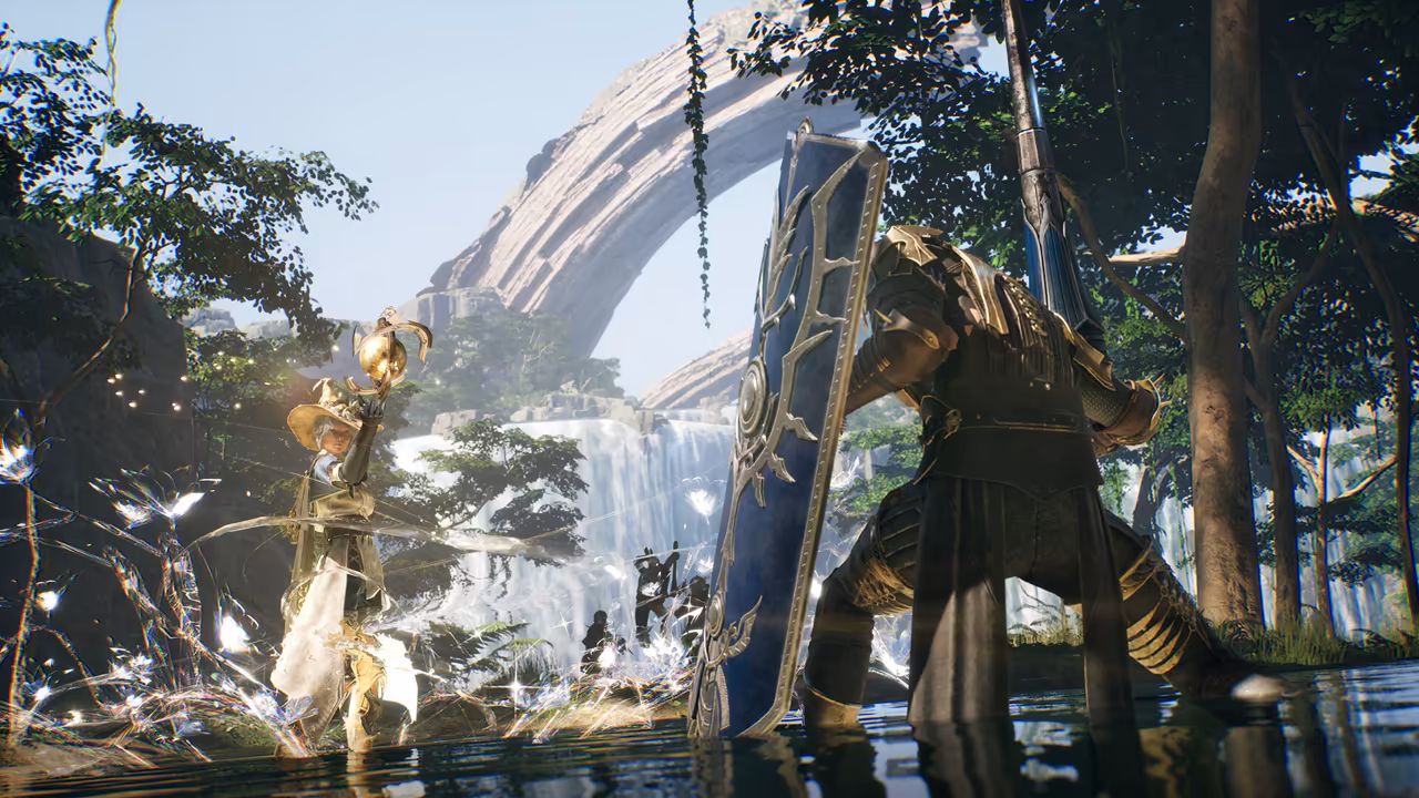 A sunlit jungle pool. At left a figure in a wide-brimmed hat with gold trim and pale robes raises a golden staff topped with a sphere, and sparkling white light swirls through the plants around her. At right a heavily armored figure kneels in the water behind a tall dark blue shield with silver ornaments, a long spear held upright. Behind them a waterfall pours beneath a huge natural stone arch, and dark silhouettes of enemies stand in the spray. No game interface is shown.