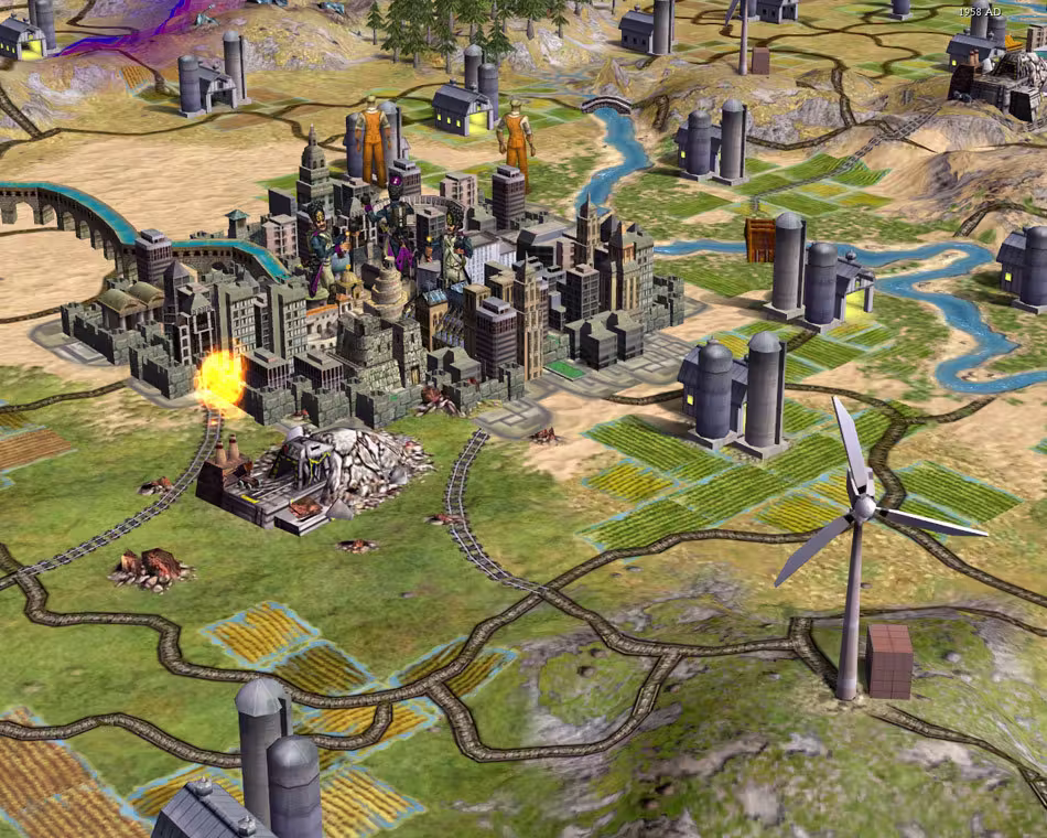 3D view of a dense city of tall gray buildings with an aqueduct, a fire burning at a factory beside it, rail lines across farm fields, grain silos and a white wind turbine in the foreground.