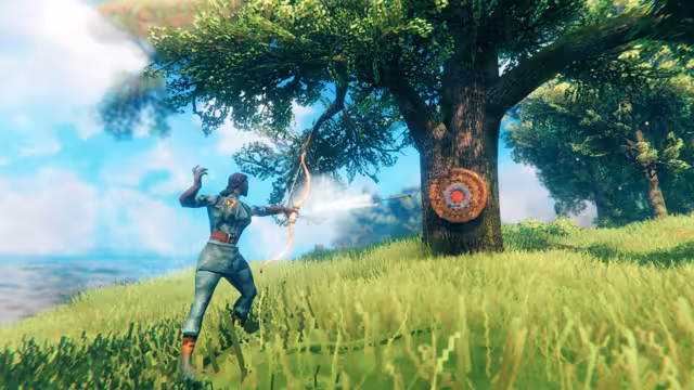 In-game screenshot of a Viking drawing a bow and shooting at a round straw target fixed to the trunk of a large oak on a grassy hill by the sea.