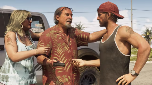 An older man with a gray goatee, sunglasses pushed up on his head and a red palm-print shirt holds out a black pistol toward a younger man in a red cap and dark tank top, while a blonde woman in a tie-dye top holds his arm, beside a white pickup truck.