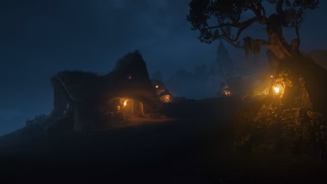 A dark blue night sky over a grassy rise. At left a cottage whose roof swells and curls like a mossy hill has a warm-lit doorway and a round window. More small lit dwellings sit beyond, and at right a gnarled tree hung with moss grows from rocks lit by a lantern. A sharp mountain peak rises in the mist behind. No game interface is shown.