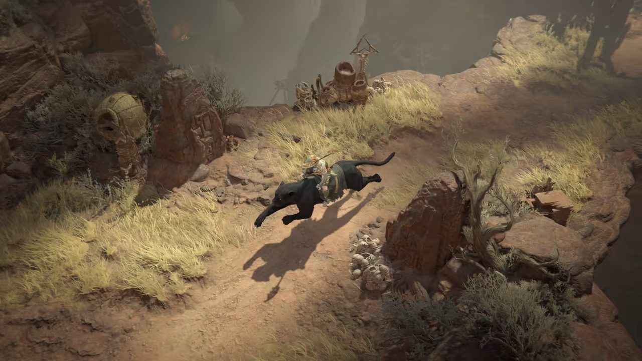 Top-down view of a dusty trail on a cliff edge with yellow grass. A large black cat carries a rider at full stride; carved red standing stones and pots line the path.