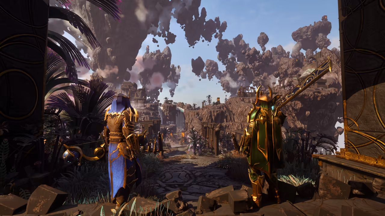 Seen from behind, two figures stand on an old paved path between dark stone gateposts. At left a figure in a long blue robe and gold armor holds a curved golden staff; at right a figure in green and gold plate armor with horned shoulders rests a huge greatsword on one shoulder. Ahead, enormous chunks of brown rock with ruins on top float in a blue sky above canyons, palms and purple-leaved plants. No game interface is shown.