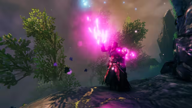 In-game screenshot: a Viking in dark robes raises a hand wreathed in bright pink magical light on a rocky outcrop surrounded by trees and mist