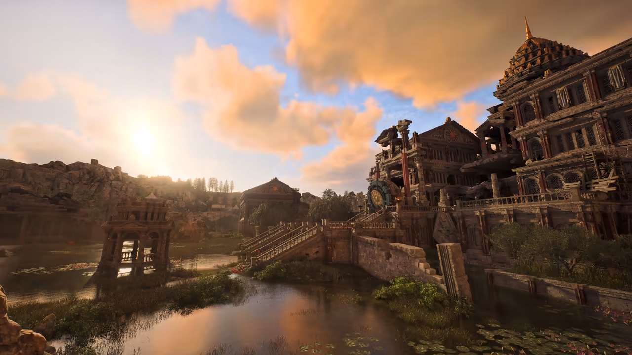 Low sun and pink clouds over a pond covered in lily pads. At right, a tall weathered palace of tan stone with red columns, arched windows and a golden dome topped by a spire; a large round bronze ornament sits on a terrace. Stone stairs lead up from the water, a small arched pavilion stands in the pond at left, and rocky hills with pine trees line the horizon. No game interface is shown.
