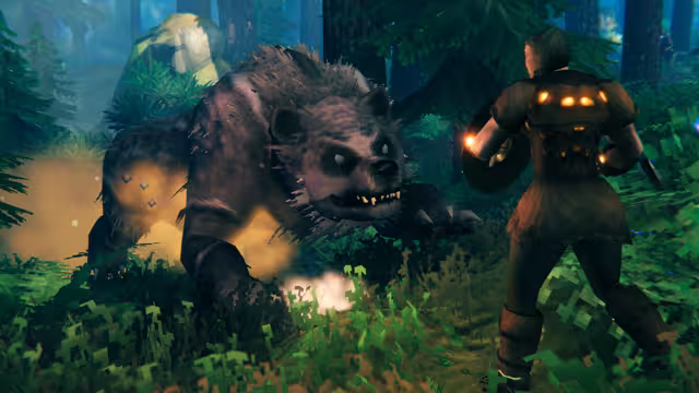 A large brown bear with bared teeth lunges toward a Viking holding a round shield and a glowing torch among pine trees.