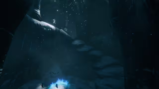 A dim blue ice cave with icicles, a glowing blue crystal cluster on the floor, several small bats in flight and a torch-bearing figure on a snowy ledge above