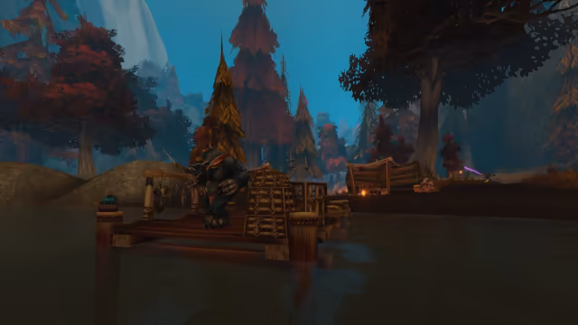 A dark-furred, bear-like furbolg with a feather in its fur and a spear crouches on a small wooden jetty over still water, next to a rack of hanging fish and wicker fish traps. On the shore beyond, a pale furbolg sits by a lean-to shelter with a small fire, among tall trees with red and gold leaves.