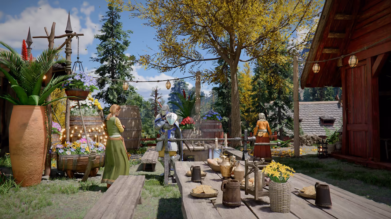 A sunny courtyard among tall trees. Long wooden tables set with mugs, bread and flowers fill the center, strings of round lanterns hang overhead, and potted palms and flower barrels line the left. A red wooden barn with an open door stands at right. A knight in shining plate armor and two women in long dresses stand among the tables.