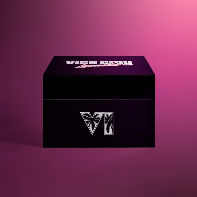 A glossy black box with a hinged lid stands on a magenta backdrop; the lid is printed with white Vice City lettering and pink Leonida script, and the front with large white numerals filled with black palm trees.