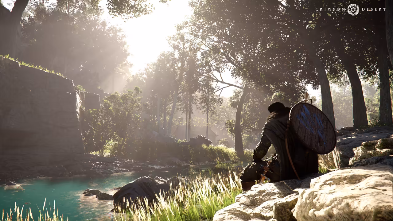 Sunlight streams through tall trees onto a shallow, clear green river. In the right foreground a man in dark clothes with a large round shield on his back sits on a pale rock among tall grass, looking toward the water and a mossy cliff at left.