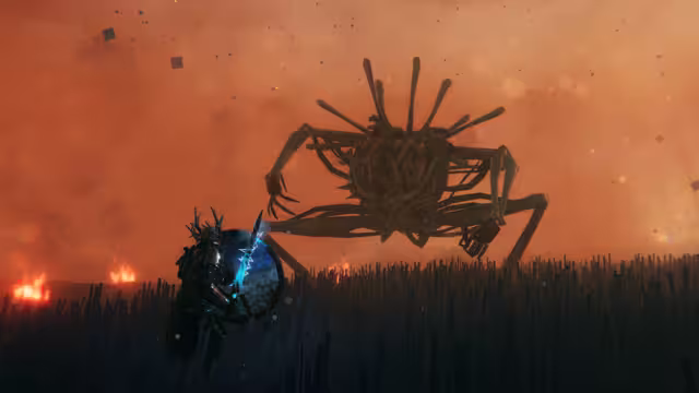 Screenshot of a huge round-bodied creature with long spindly limbs looming over an armored player who holds up a glowing blue shield, orange haze behind