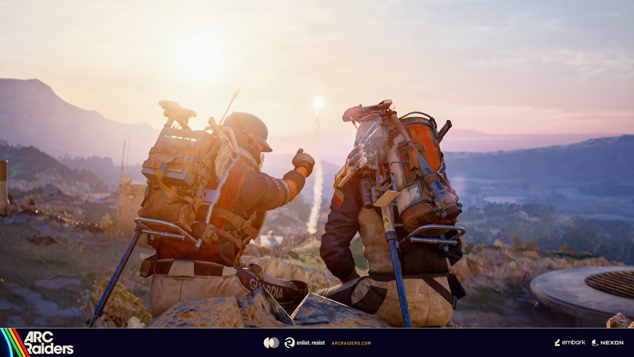 Backs of two figures on a rocky lookout in hazy pink and gold light.