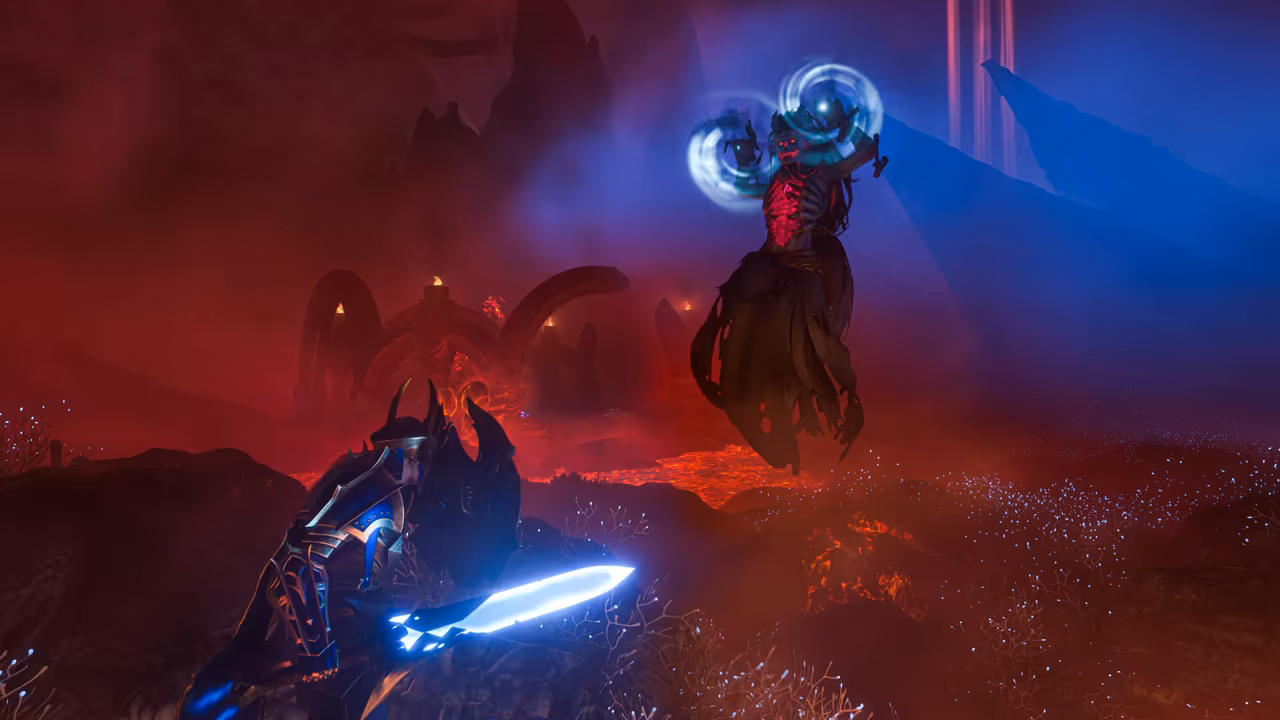 Red fog and glowing lava cover dark ground strewn with pale grass. In the foreground a figure in dark blue armor with tall horned pauldrons kneels holding a sword that glows bright blue. Above, a gaunt skeletal figure in a tattered dark robe floats in the air, its ribcage glowing red, holding up two whirling rings of blue light. Stone arches stand in the haze behind. No game interface is shown.