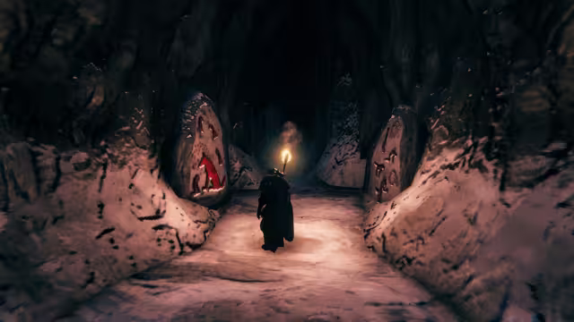 A cloaked Viking holding a torch walks away down a snow-floored rock tunnel between two upright stones decorated with red painted figures, one of them a wolf-like animal.