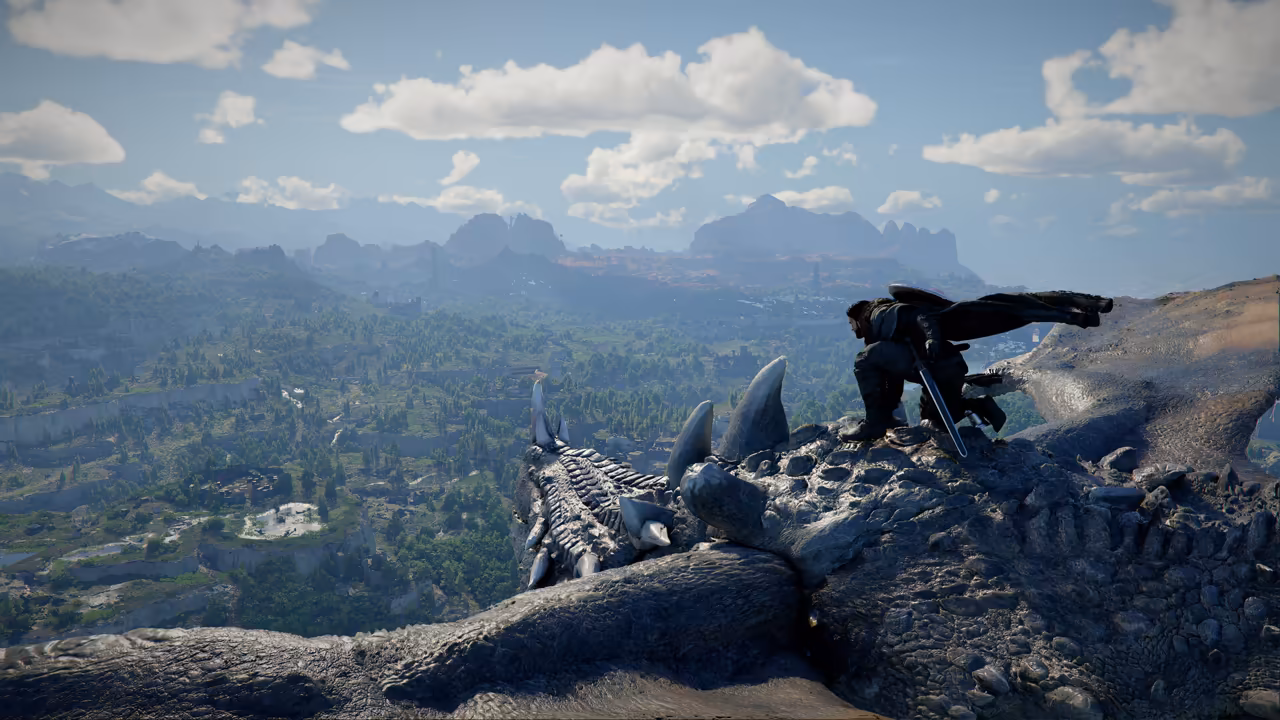 From high up, a man in dark armor with a flapping black cloak kneels on the rough, spiked gray hide of a huge creature, a sword at his side. Far below stretches a broad valley of forests and fields to distant mountains under a blue sky with white clouds.