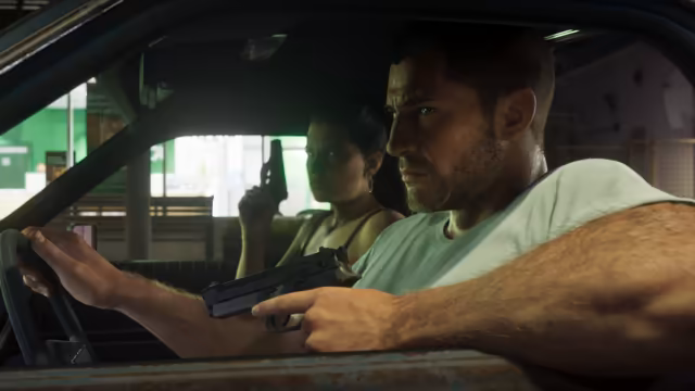 Seen through a car window, a man in a pale T-shirt grips the steering wheel with one hand and holds a pistol with the other, while a woman in the back seat holds a pistol upright, outside a store with a green sign.