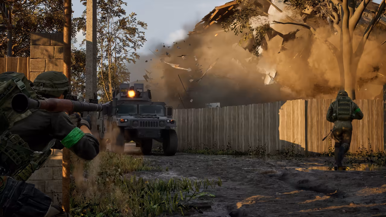 A soldier at left aims a rocket launcher across a yard toward a dark armored vehicle; behind it a wall of debris and dust bursts from a building, and another soldier runs at right.