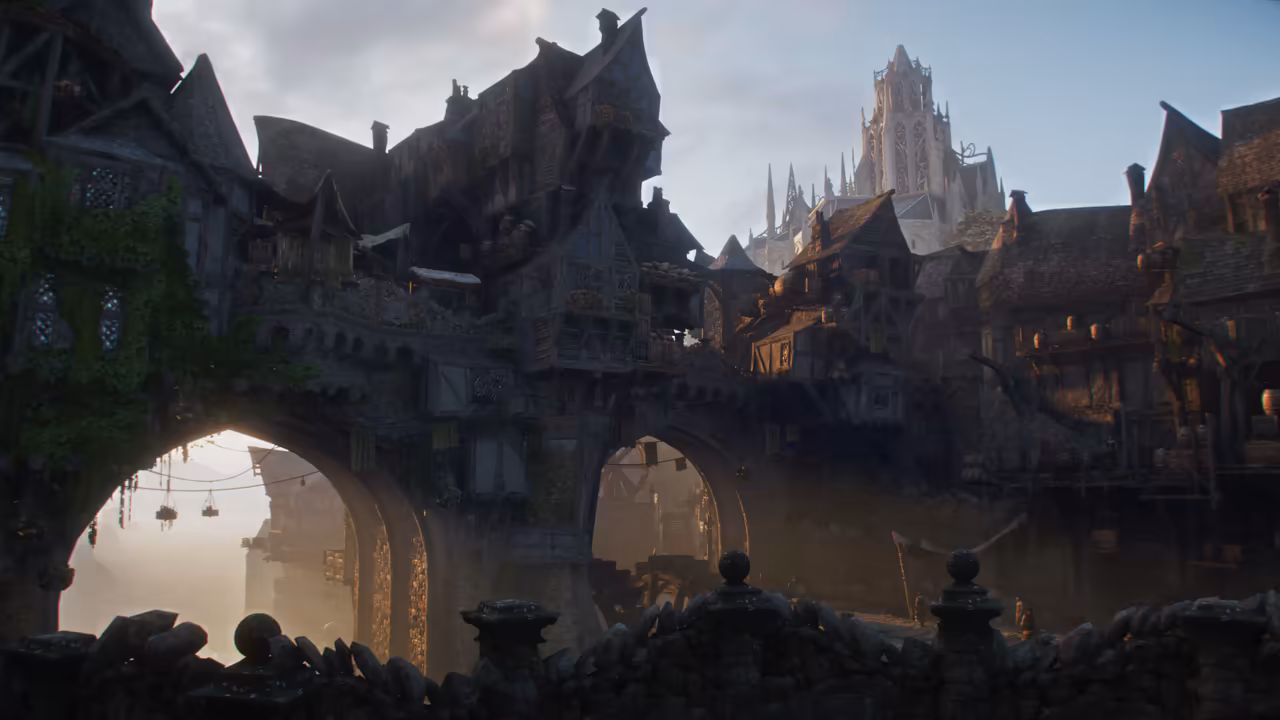 Seen past a low stone wall topped with round finials, a dense old city of leaning, multistory timbered houses with balconies and ivy sits on a massive stone bridge or wall pierced by arches. Through the arches hazy light shows hanging lanterns and more buildings. Behind, a tall pale Gothic spire stands against a cloudy sky. No game interface is shown.