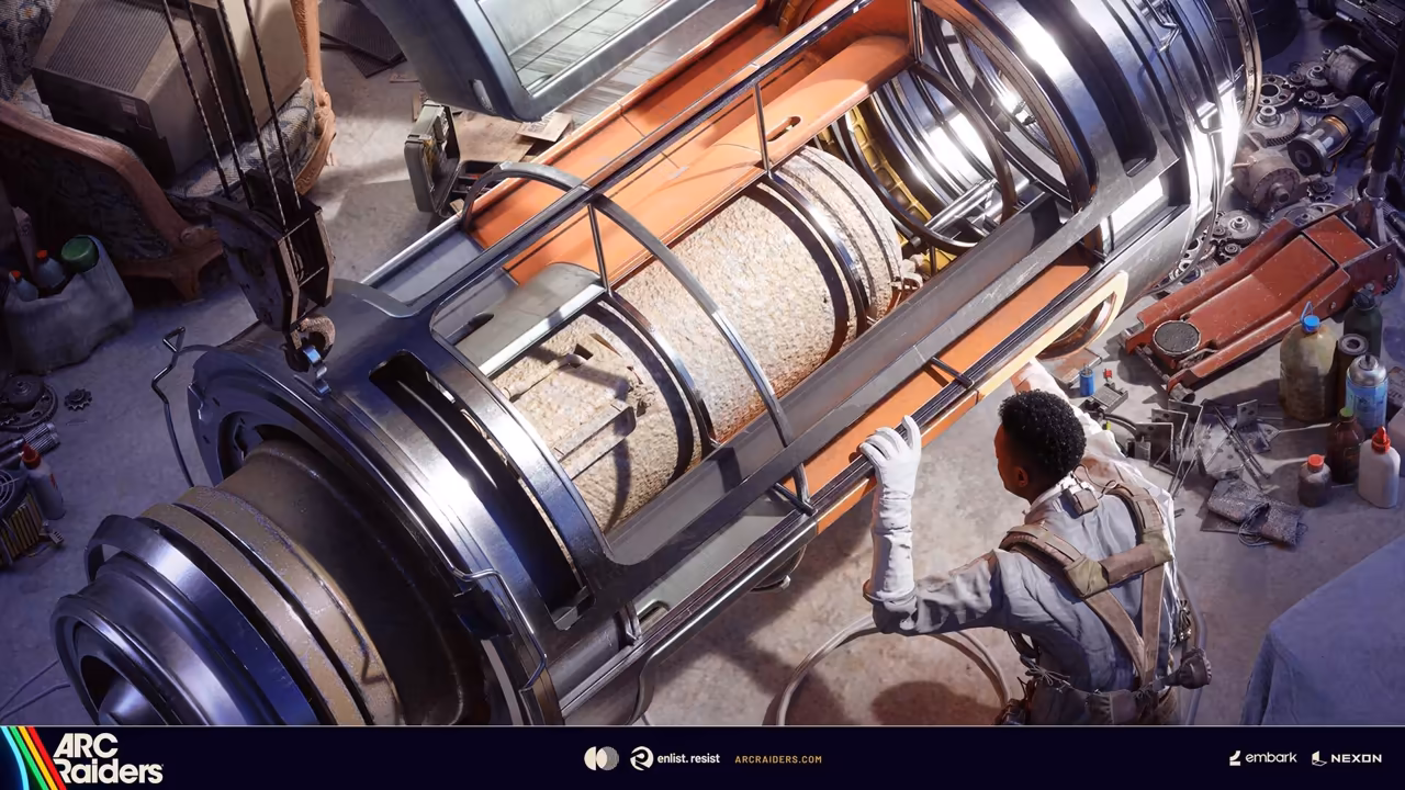 High view of a person in a white coat beside a giant metal drum among tools and parts.