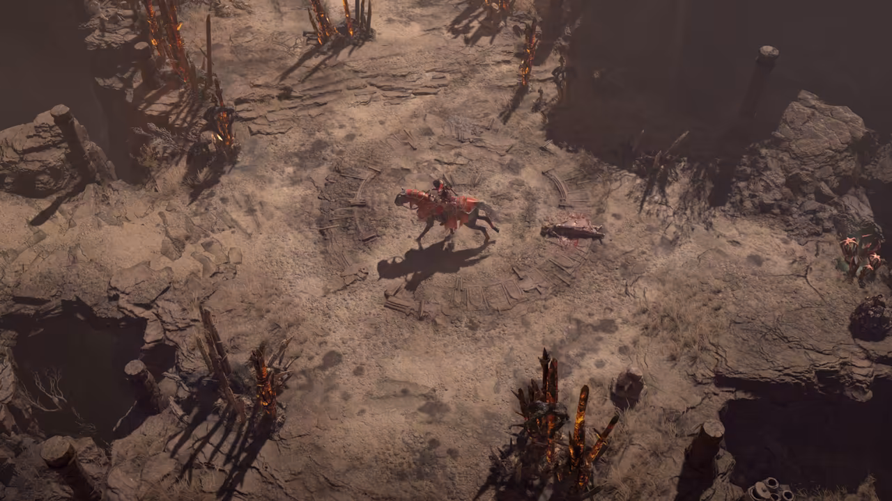 Top-down view of a dirt clearing with a faint circular pattern. A mounted rider on a horse draped in red cloth crosses the middle; charred wooden stakes with glowing embers stand around the edge.
