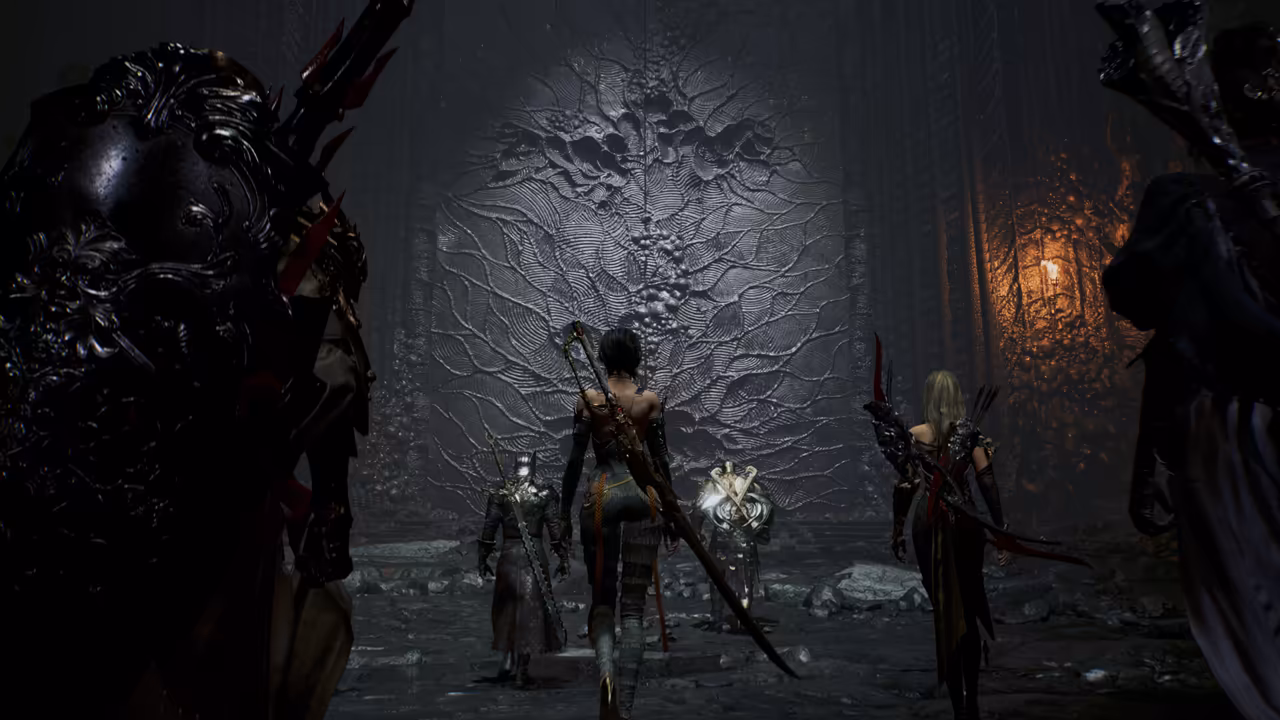 A dark cavern with rough walls. In the foreground a figure in black ornamented armor fills the left edge. Ahead, four more armed figures walk away from the viewer toward a vast gray wall covered in carved, branching, root-like shapes that spread from its center: one with a saw-toothed greatsword, a woman with a long curved blade on her back, an armored knight and a blond archer with a bow and red trim. A single torch burns on the right wall. No game interface is shown.