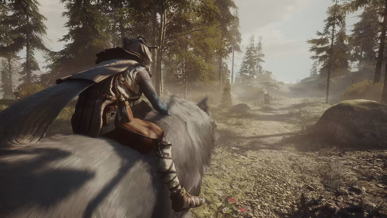 A rider in a hood and a long quilted cloak, one bare arm marked with blue tattoos resting on thick white fur, sits on the back of an enormous white wolf whose ear shows at the right of the frame. A gravel path winds ahead between tall pine trees and mossy boulders in misty, golden light. No game interface is shown.