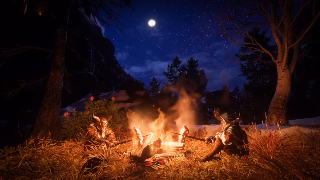 Night in a forest clearing lit by a large campfire. Two figures in armor sit in the dry grass on either side of the fire, each holding a stick with food over the flames; the one at left wears a helmet with curved horns. A full moon and stars shine above dark pines, a pale birch stands at right, and patches of snow lie on the ground behind. No game interface is shown.