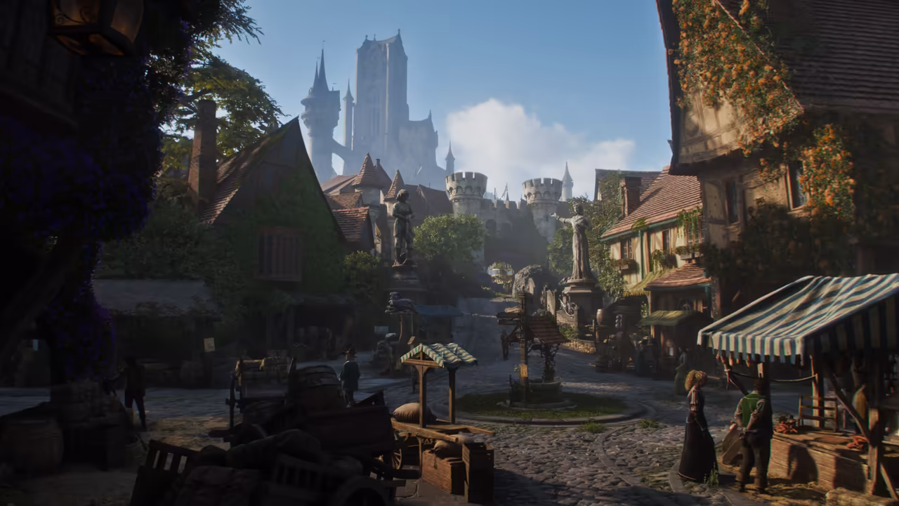 Shaded town square of timbered houses with steep tiled roofs and ivy. A covered well stands in the middle beside a signpost, with stone statues on pedestals beyond. At right a stall with a green and white striped awning, two people talking beside it; at left barrels, crates and a wooden cart. Above the roofs, round towers and a tall white castle with spires rise against a blue sky. No game interface is shown.