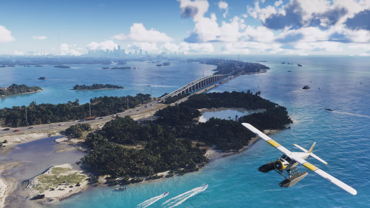 Aerial view of green, mangrove-covered islands in turquoise water joined by a long road bridge, with speedboats trailing wakes and a white and yellow seaplane in the foreground, and a city skyline on the horizon under white clouds.