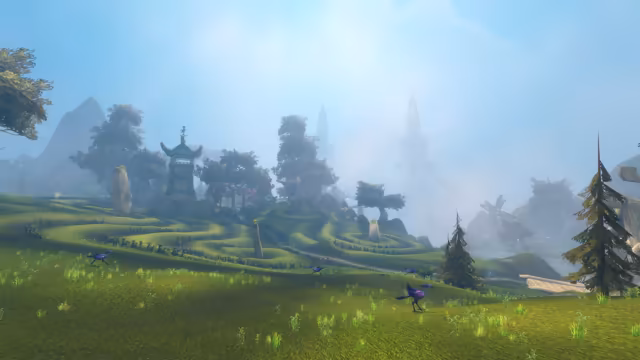 Several long-legged birds with purple and blue feathers run over a sunlit grassy slope. Behind them, curving terraces of low hedges climb past standing stones to a stone tower with an upswept roof among trees, while pale towers, one hung with a huge chain, fade into blue mist.