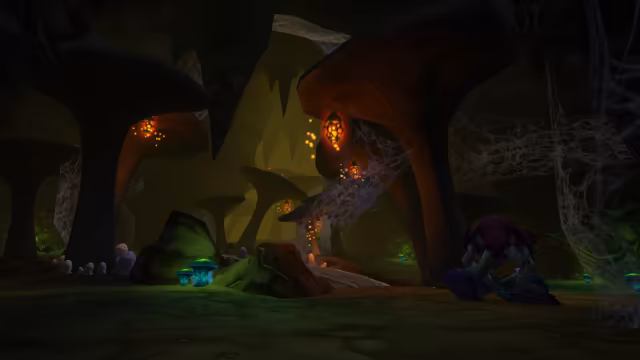 A dark cavern of towering mushroom-shaped rock pillars is strung with thick cobwebs and lit by glowing orange pods that shed sparks, with teal mushrooms and pale egg-like mounds on the green-tinged floor. Small red-marked spiders crawl at left, and a hunched creature with a purple mane stands with its back to the viewer at right.