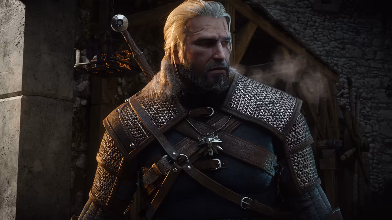 A close-up of a gray-bearded man with long white hair, a scar over his left eye and yellow cat-like eyes, wearing chain mail with leather straps and a silver wolf-head medallion, a sword hilt over his shoulder. Behind him are a stone pillar, a hanging iron brazier and a dark stone wall, and no game interface is shown.