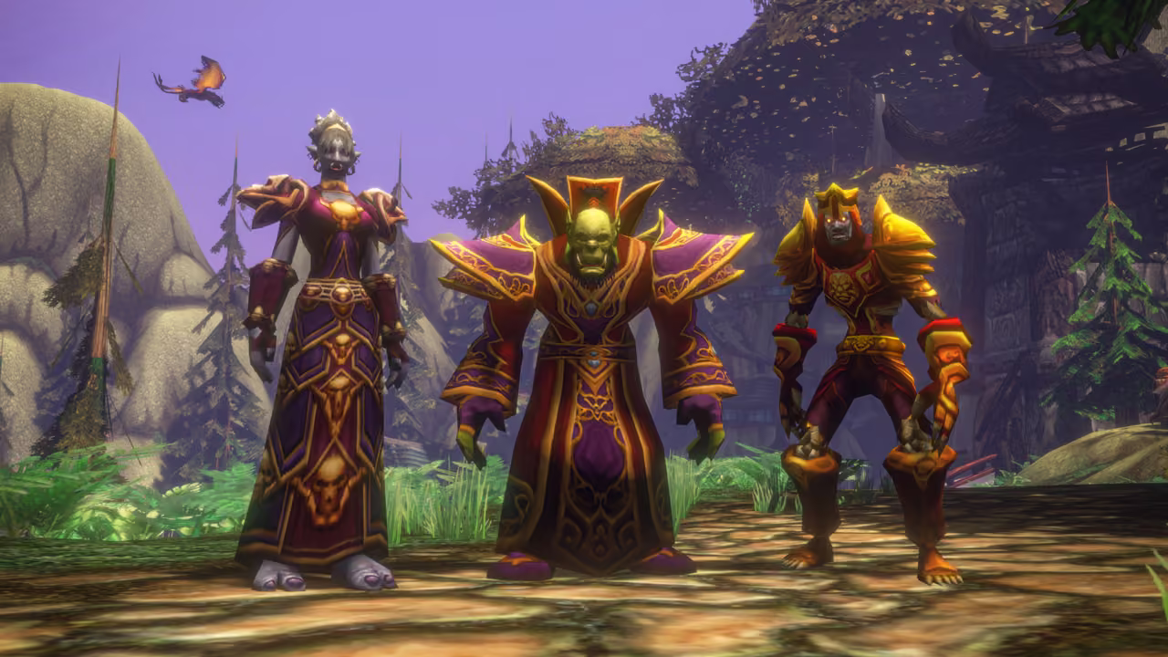 A gray-skinned troll woman with small tusks in a purple and gold robe decorated with skulls, a green-skinned orc in red, purple and gold robes with a tall collar, and a skeletal undead in gold and red plate armor with a lion emblem stand on a sun-dappled forest path. Behind them are pine trees, gray boulders, a large wooden building among the trees and a winged creature in a violet sky.