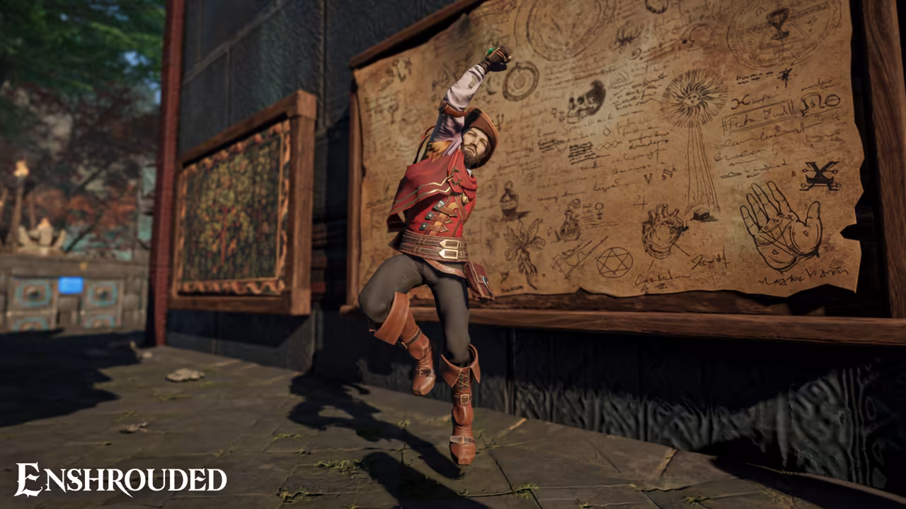 Indoors on a stone floor. A bearded man in a red vest over a white shirt, brown trousers and tall red boots kicks up one leg and raises an arm in a dance. Behind him hangs a huge parchment on a wooden frame covered with pencil sketches of hands, skulls, a pyramid and symbols, beside a framed tapestry. The Enshrouded logo is at bottom left.